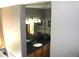 Bathroom vanity area featuring dark countertop, a sink, and modern light fixture at 9274 Sandy Ln, Conifer, CO 80433