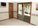 Bedroom with tile floors, sliding glass doors to the exterior, and a wall-mounted television at 9274 Sandy Ln, Conifer, CO 80433