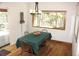 Dining room with a table set for a meal, hardwood flooring, and a large window at 9274 Sandy Ln, Conifer, CO 80433