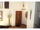 Foyer with wood-look flooring and trim, textured walls, and decorative light fixtures at 9274 Sandy Ln, Conifer, CO 80433
