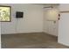 Spacious garage with a window, ample storage, and wall mounted TV at 9274 Sandy Ln, Conifer, CO 80433