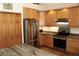 Kitchen with stainless steel appliances, granite countertops, wood cabinets and hardwood floors at 9274 Sandy Ln, Conifer, CO 80433