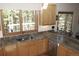 Kitchen featuring granite counters, wood cabinets, and scenic views from the window over the sink at 9274 Sandy Ln, Conifer, CO 80433