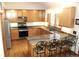 Kitchen with stainless steel appliances, granite countertops, wood cabinets and hardwood floors at 9274 Sandy Ln, Conifer, CO 80433
