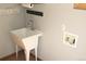 Laundry room featuring a utility sink, decor, and signage at 9274 Sandy Ln, Conifer, CO 80433