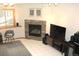 Cozy living room with a marble fireplace, tile floor, and a view from the window at 9274 Sandy Ln, Conifer, CO 80433