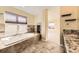 Spa-like bathroom with soaking tub and fireplace at 19406 E Maplewood Pl, Aurora, CO 80016