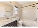 Bathroom with white tiled shower/tub, vanity sink, and window at 19406 E Maplewood Pl, Aurora, CO 80016