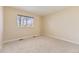 Bright bedroom with neutral walls, soft carpet flooring, and natural light from the window at 19406 E Maplewood Pl, Aurora, CO 80016