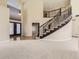 Spacious foyer featuring a grand staircase, chandelier, and hardwood floors at 19406 E Maplewood Pl, Aurora, CO 80016