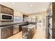 Modern kitchen featuring stainless steel appliances, granite countertops, and a center island at 19406 E Maplewood Pl, Aurora, CO 80016