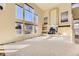 Bright living room with large windows, fireplace, and built-in shelving at 19406 E Maplewood Pl, Aurora, CO 80016