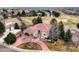 Expansive home with red tile roof, mature trees, circular driveway, and golf course community at 7022 Secrest Ct, Arvada, CO 80007