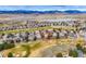 Elevated perspective of a home situated on a golf course with lake and mountain views in the distance at 7022 Secrest Ct, Arvada, CO 80007