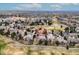 Aerial view of a home with red tile roof encircled with landscaping and a large backyard at 7022 Secrest Ct, Arvada, CO 80007