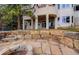 Beautiful backyard with stone patio, retaining wall, and access to the home's lower level at 7022 Secrest Ct, Arvada, CO 80007