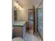 Bathroom featuring a vanity with decorative tile and shower/tub combo with colorful accents at 7022 Secrest Ct, Arvada, CO 80007