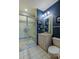 Charming bathroom features decorative tile, glass shower, and modern fixtures at 7022 Secrest Ct, Arvada, CO 80007