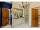 Bathroom features patterned tile, a modern vanity, and a glass-enclosed shower at 7022 Secrest Ct, Arvada, CO 80007