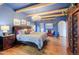Spacious bedroom offers hardwood floors, chandelier lighting, and access to multiple rooms at 7022 Secrest Ct, Arvada, CO 80007