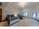 Spacious bedroom with two beds, natural light from windows, and a stylish chandelier at 7022 Secrest Ct, Arvada, CO 80007