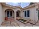 Private courtyard with stone pavers and a charming entrance featuring string lights and stucco arches at 7022 Secrest Ct, Arvada, CO 80007