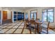 Dining room with custom tile floors, large windows, and a dining table set for six at 7022 Secrest Ct, Arvada, CO 80007