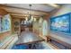 Elegant dining room with wooden beams, large wooden table, and unique decorative accents at 7022 Secrest Ct, Arvada, CO 80007