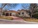 Charming stucco home features a beautiful red tile roof, landscaped yard, and spacious three-car garage at 7022 Secrest Ct, Arvada, CO 80007