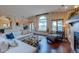 Inviting living room with hardwood floors, large windows, comfortable seating, and a fireplace at 7022 Secrest Ct, Arvada, CO 80007