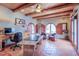 Cozy office featuring a wooden ceiling, custom desk, tiled flooring, and shuttered windows at 7022 Secrest Ct, Arvada, CO 80007