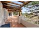 Inviting covered deck with wood pergola and open views of the surrounding landscape at 7022 Secrest Ct, Arvada, CO 80007
