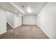 Spacious carpeted basement with white walls and ceiling, ideal for recreation or storage at 348 Emery Rd, Northglenn, CO 80233