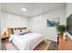 Finished basement bedroom with a comfortable bed and ample light at 348 Emery Rd, Northglenn, CO 80233
