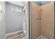 Bathroom with standing shower stall, light blue walls, and tiled shower at 348 Emery Rd, Northglenn, CO 80233