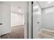 A view into the bathroom that includes a toilet, light wood floors, and a window at 348 Emery Rd, Northglenn, CO 80233