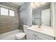 Clean bathroom with gray tile and updated vanity at 348 Emery Rd, Northglenn, CO 80233