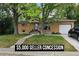 Charming brick home features an attached garage, landscaped yard, and a relaxing hammock hanging from a mature shade tree at 348 Emery Rd, Northglenn, CO 80233