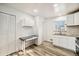 White kitchen with modern appliances and updated flooring at 348 Emery Rd, Northglenn, CO 80233