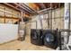 Utility room with washing machine, dryer, and water heater on a concrete floor at 348 Emery Rd, Northglenn, CO 80233