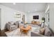 Inviting living room featuring a plush rug, comfortable seating, and an open view to the kitchen at 348 Emery Rd, Northglenn, CO 80233