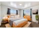 Serene bedroom featuring hardwood floors, natural light, and stylish furnishings at 348 Emery Rd, Northglenn, CO 80233