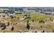 Broad aerial view of sprawling land featuring scattered trees and distant structures at 8855 E Parker Rd, Parker, CO 80138
