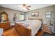 This bedroom features hardwood floors, a ceiling fan, and a neutral color scheme at 8855 E Parker Rd, Parker, CO 80138