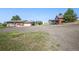 A charming exterior view of home with a large gravel driveway, an attached garage, and a carport at 8855 E Parker Rd, Parker, CO 80138