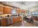 Well-lit kitchen featuring tile flooring, wooden cabinetry, stainless steel appliances, and a breakfast nook at 8855 E Parker Rd, Parker, CO 80138