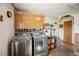 The laundry room features a washer and dryer, upper cabinets, and a view to the hallway at 8855 E Parker Rd, Parker, CO 80138