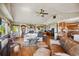 Spacious living room featuring hardwood floors, vaulted ceiling, exposed brick fireplace, and lots of natural light at 8855 E Parker Rd, Parker, CO 80138