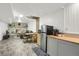 Basement view of the living area and kitchenette that offers functionality and style at 6896 Ruth Way, Denver, CO 80221