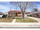 Charming brick home with a well-maintained front yard and covered parking at 6896 Ruth Way, Denver, CO 80221